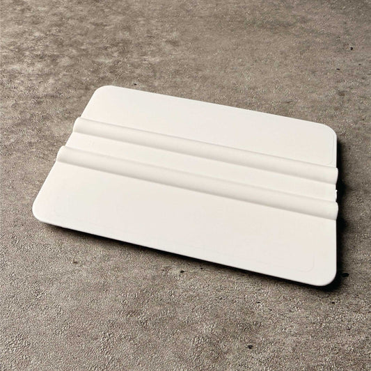 Sign making squeegee on grey concrete background